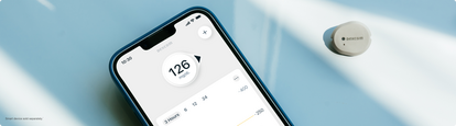 Phone with reading up and sensor sitting on table