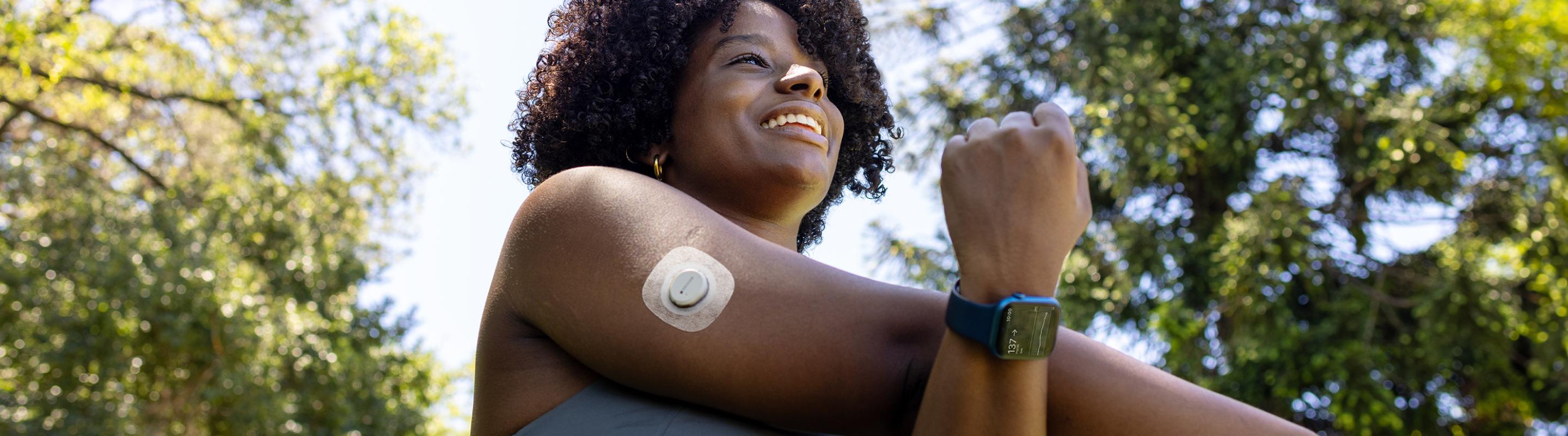 woman wearing the Dexcom ONE+ sensor